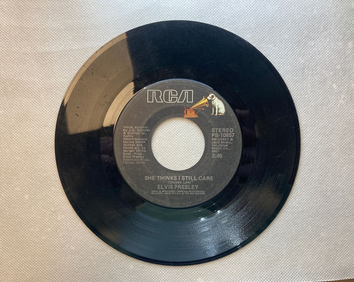 45 double sided Elvis Presley record "She thinks I still care" and "Moody Blue"