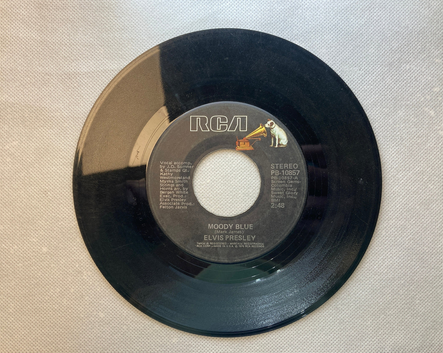 45 double sided Elvis Presley record "She thinks I still care" and "Moody Blue"