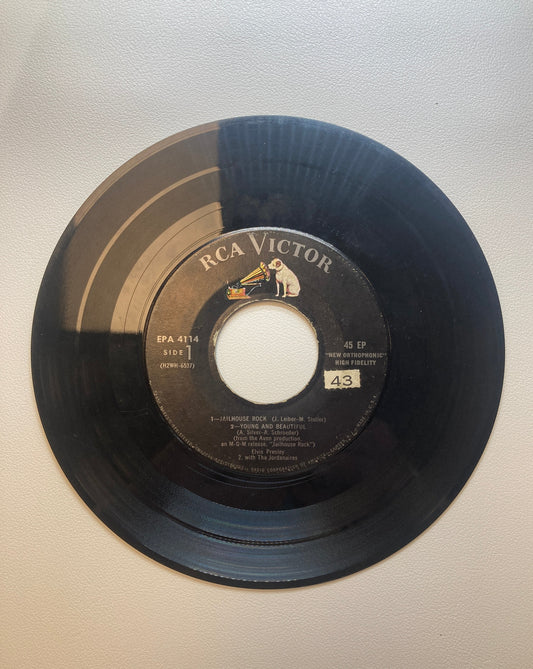 45 double sided Elvis Presley record "Jailhouse Rock", "Young and Beautiful", "I want to be free" , "Don't leave me now", and Baby I don't care"