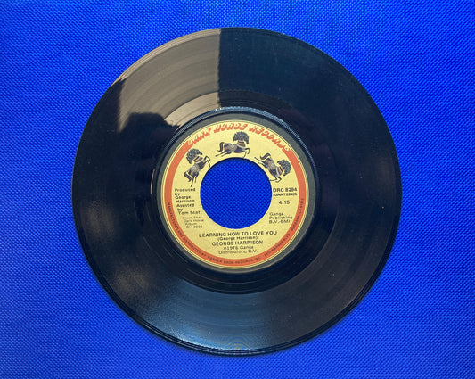 45 double sided George Harrison record "Learning how to love you" and "This song"