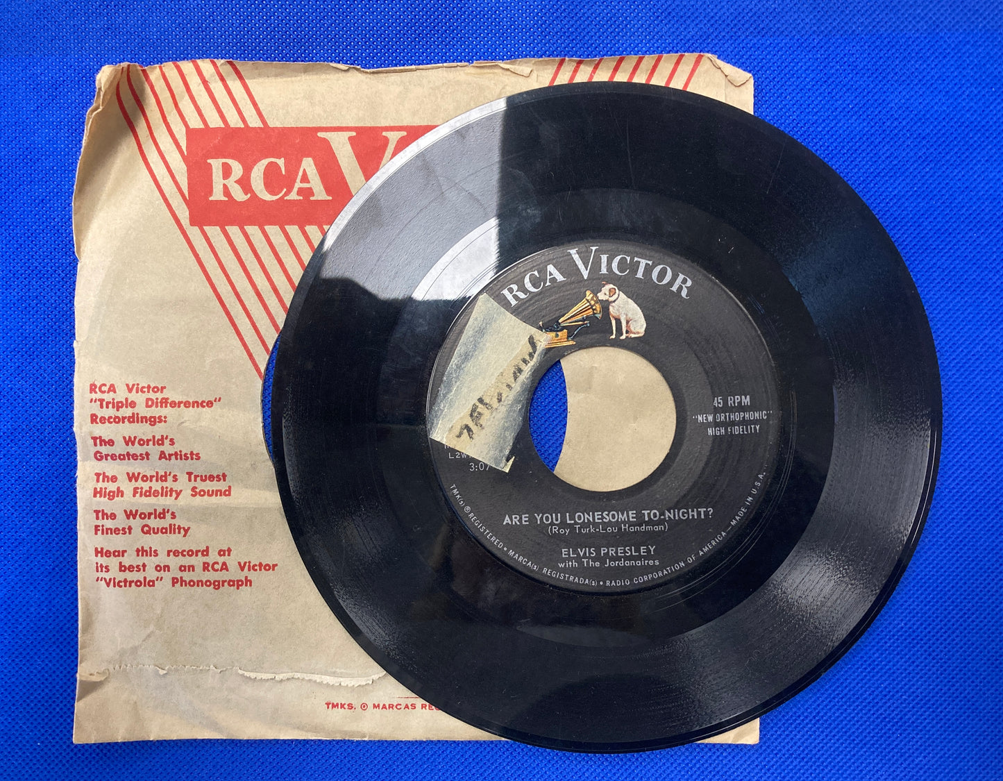 45 double sided Elvis Presley record with plain sleeve "I gotta know" and "Are you lonesome tonight"