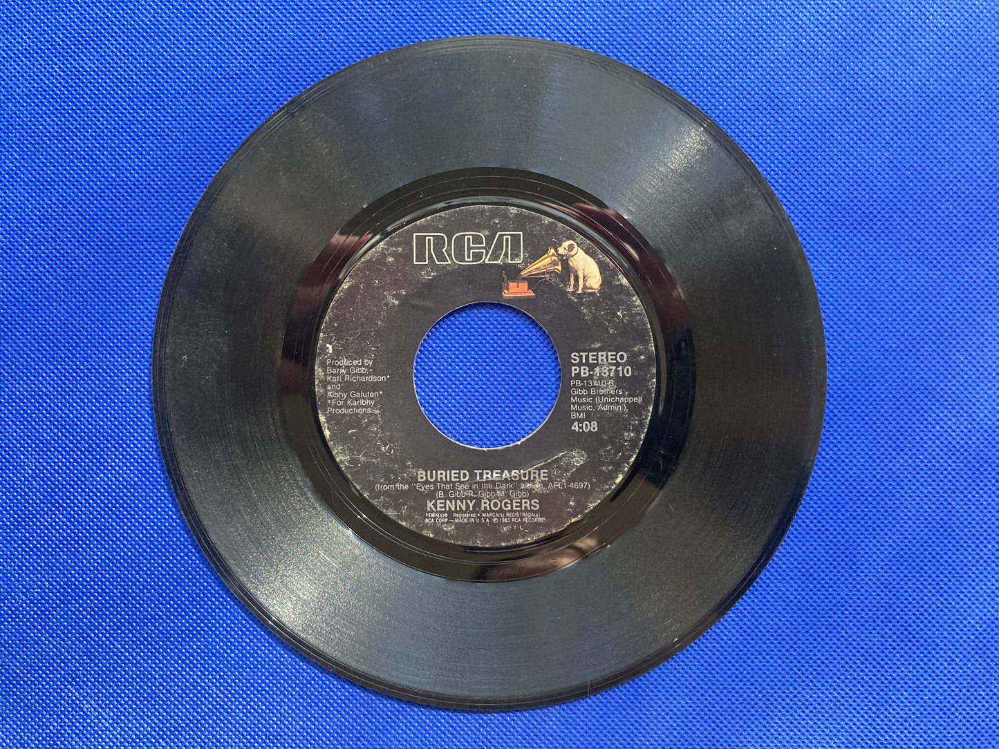 45 double sided Kenny Rogers record "This Woman" and "Buried Treasure"